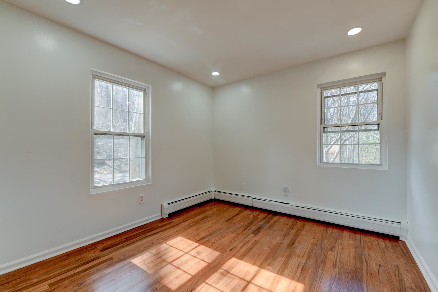 10 Toye Street Randolph, NJ 07869 - Photo 17 of 48 an empty room with wooden floor and windows