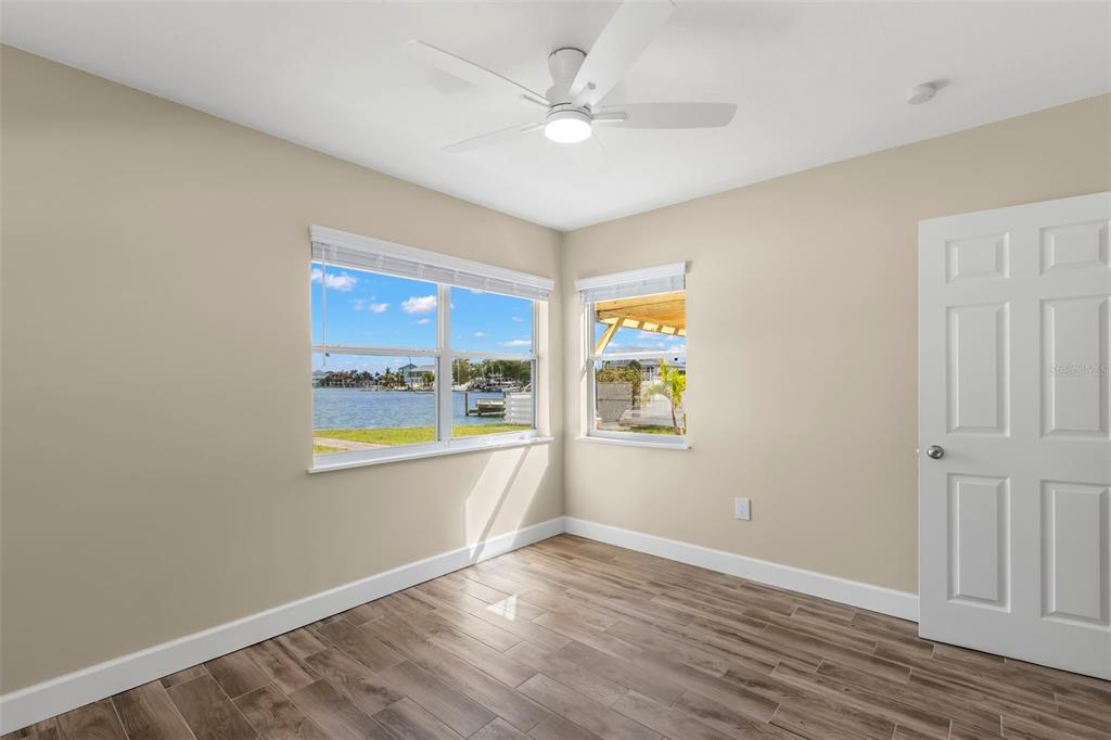 708 Sunset Cove Madeira Beach, FL 33708 - Photo 31 of 61 an empty room with window and wooden floor