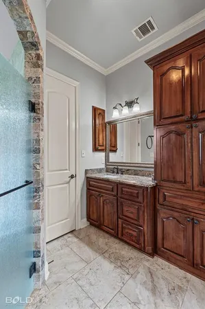 a room with granite countertop a sink and a refrigerator