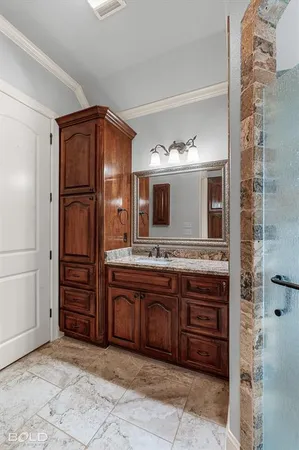 a spacious bathroom with a granite countertop sink and mirror