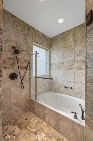 a bathroom with a bathtub and shower