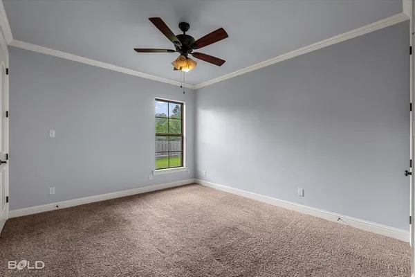 an empty room with a ceiling fan and window