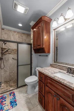 a bathroom with a sink a toilet and shower