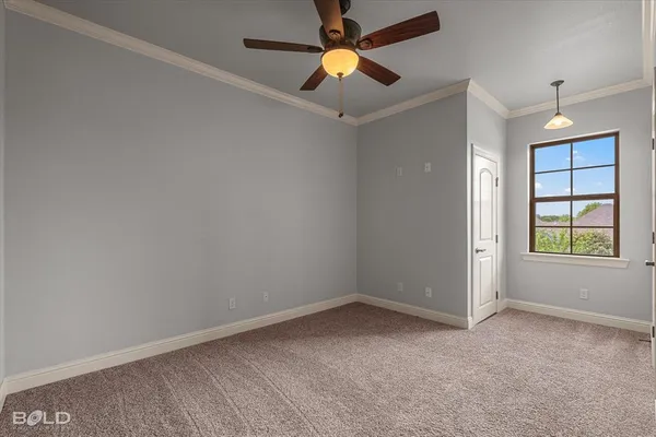 en empty room with windows and a ceiling fan