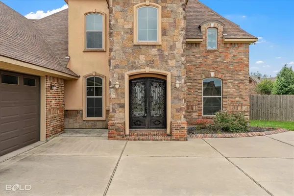 front view of a brick house with a small yard