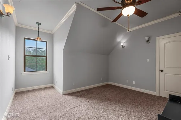 an empty room with ceiling fan and window