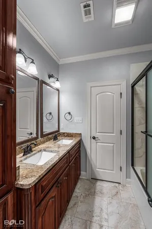 a bathroom with a granite countertop sink a mirror and a shower