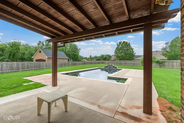 a view of a patio with a table chairs and a backyard