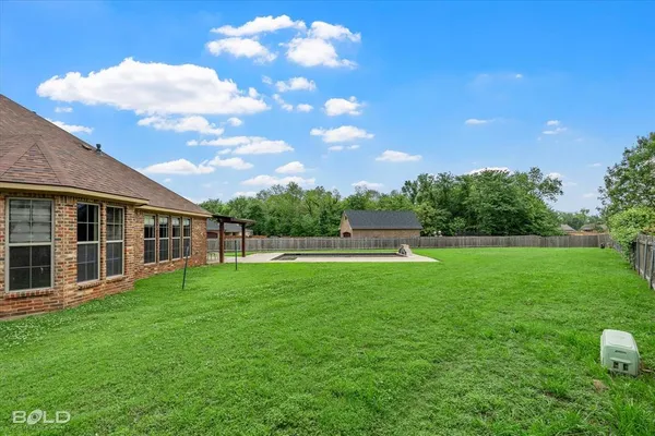 a view of a house with a backyard