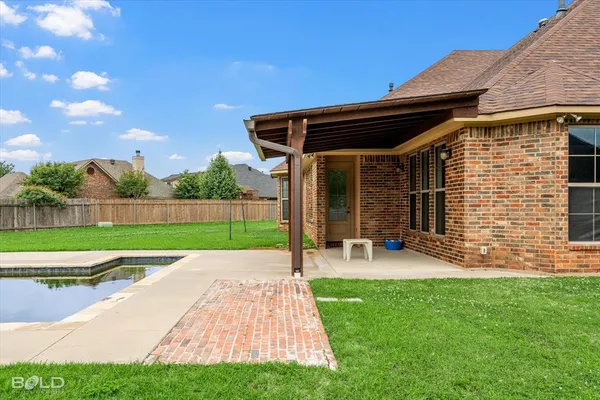 a view of a backyard with sitting area and slide