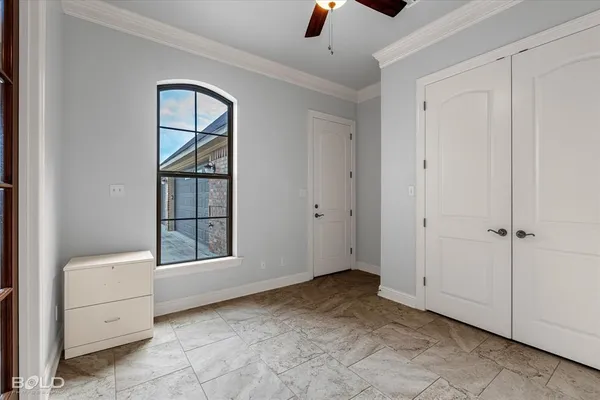 an empty room with windows and closet