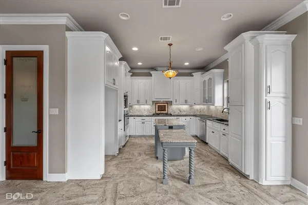 a kitchen with a refrigerator a sink and chairs