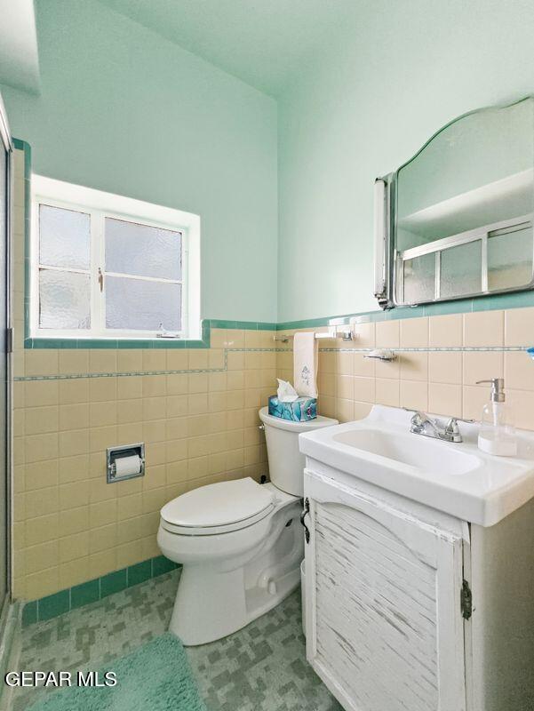 4135 Emory Road El Paso, TX 79922 - Photo 51 of 73 a bathroom with a granite countertop toilet sink and mirror