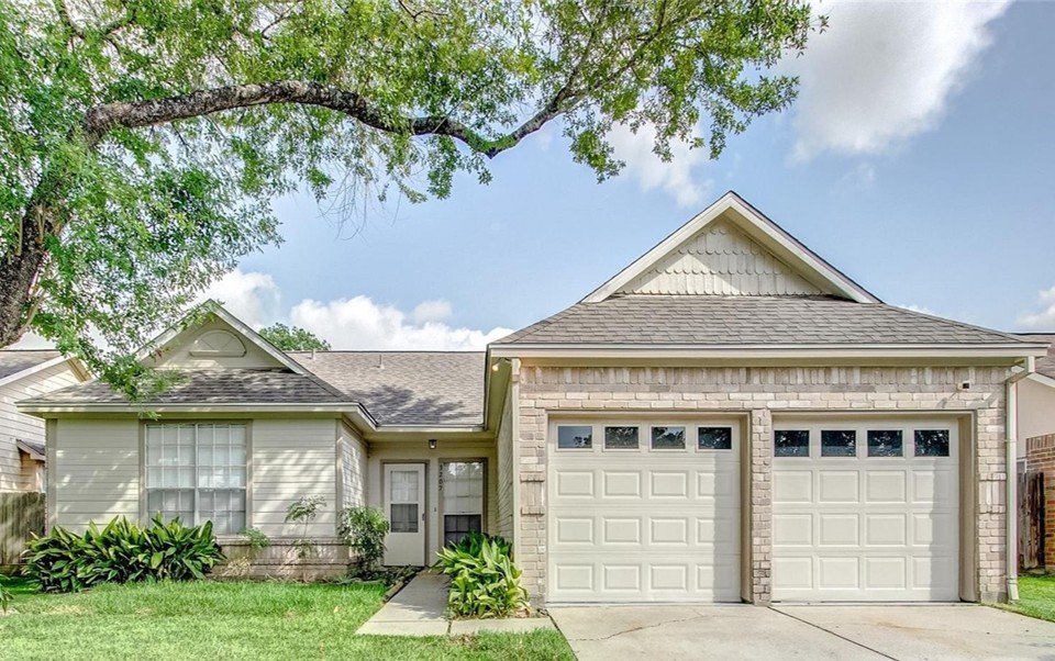 3207 Georgia Pine Drive Spring, TX 77373 - Photo 2 of 29 a front view of a house with a yard and potted plants