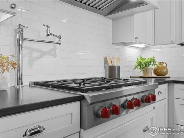 a kitchen with stainless steel appliances granite countertop a stove and a sink