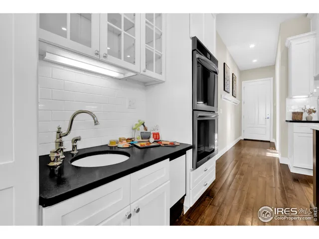 a view of a dining room with furniture wooden floor and chandelier