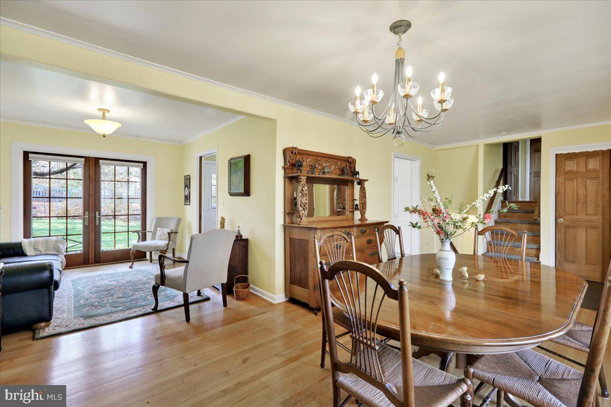 250 Clearfield Road New Providence, PA 17560 - Photo 12 of 35 a view of a dining room with furniture a chandelier and wooden floor