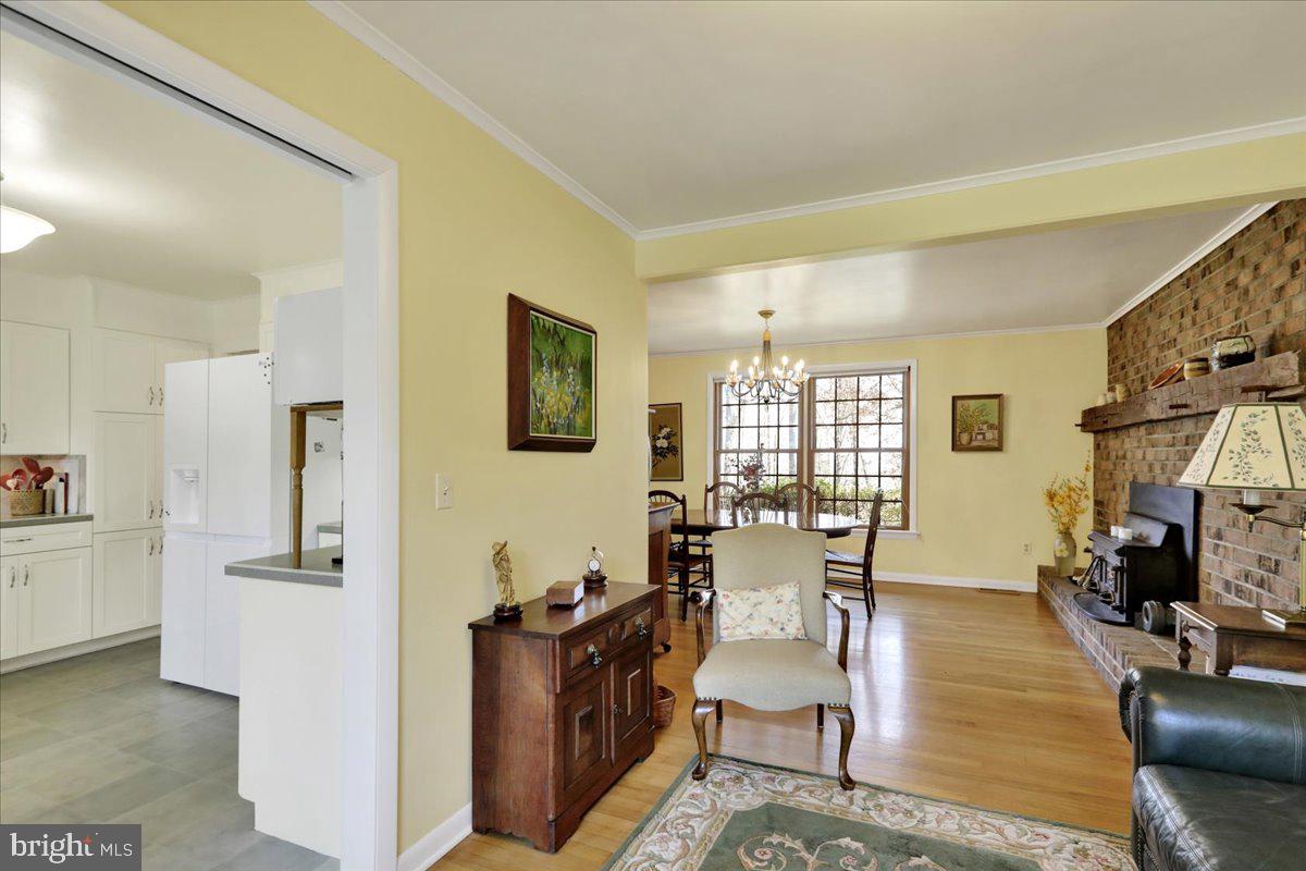 250 Clearfield Road New Providence, PA 17560 - Photo 14 of 35 a view of a livingroom with furniture a fireplace and wooden floor