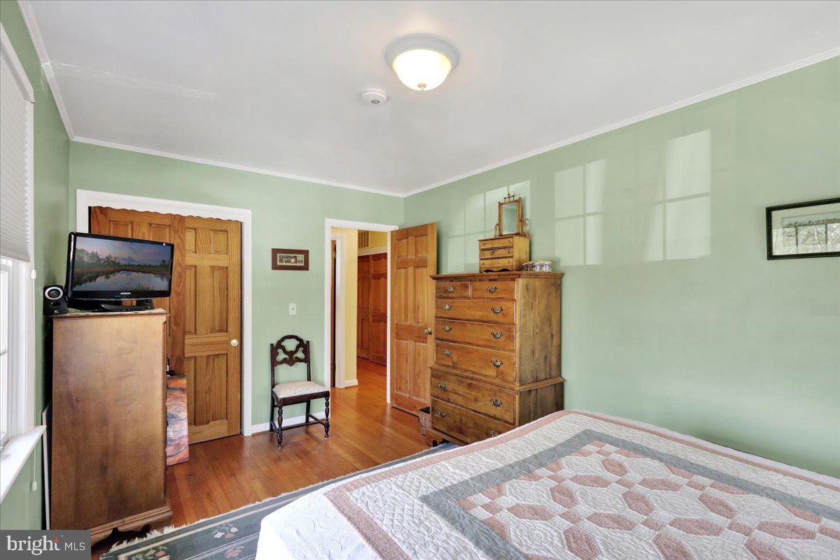 250 Clearfield Road New Providence, PA 17560 - Photo 19 of 35 a bedroom with a bed and wooden floor