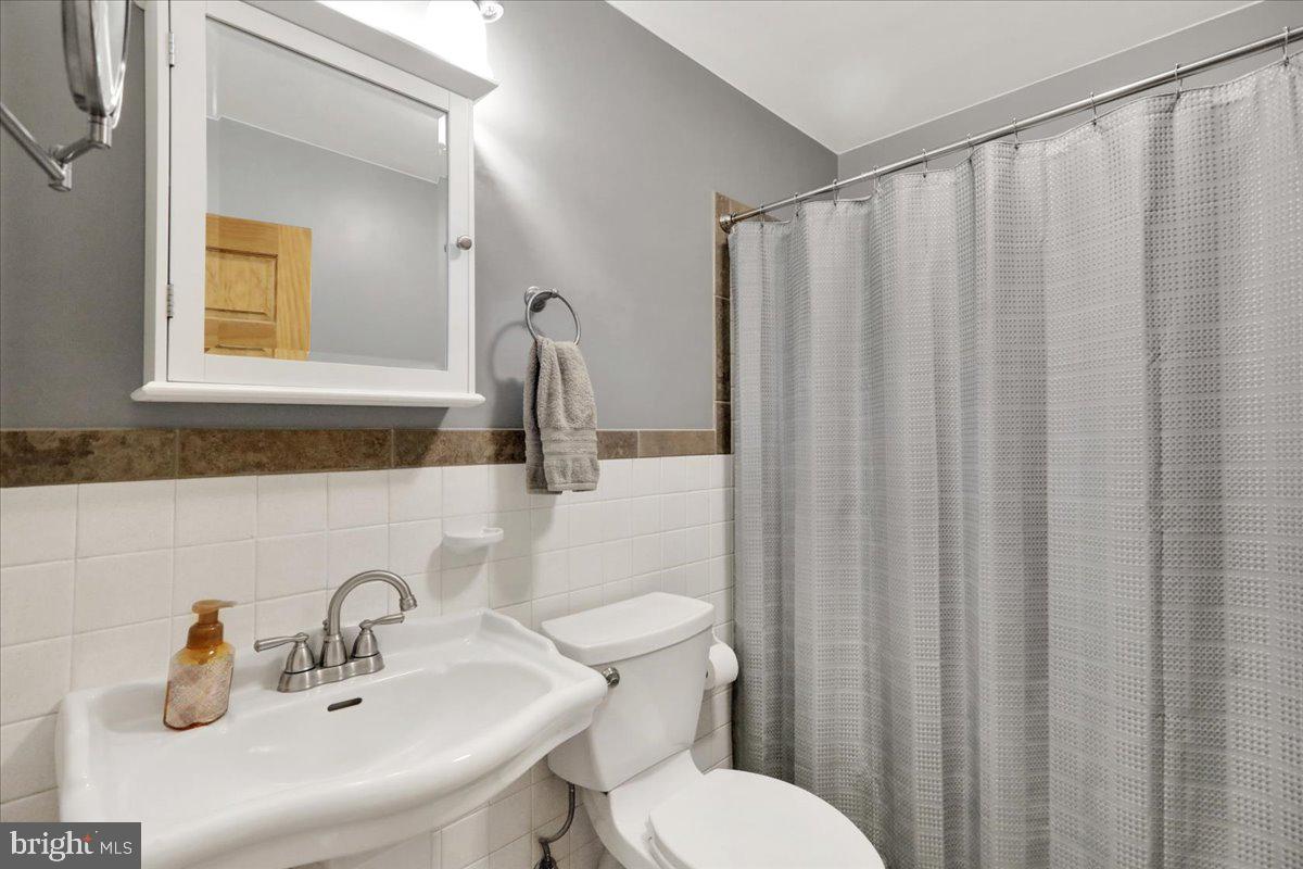 250 Clearfield Road New Providence, PA 17560 - Photo 20 of 35 a bathroom with a sink a mirror a toilet and shower