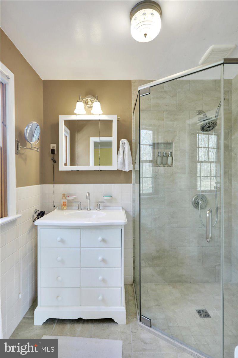 250 Clearfield Road New Providence, PA 17560 - Photo 25 of 35 a bathroom with a double vanity sink and mirror with shower