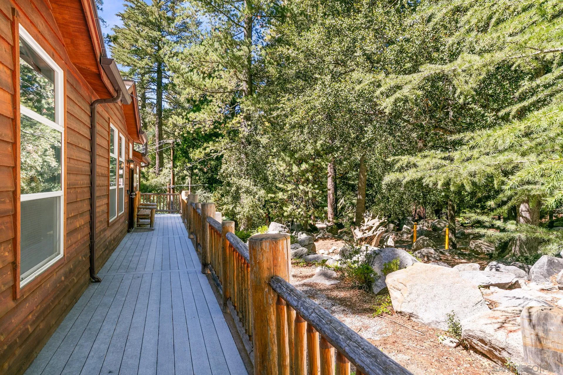 24655 Upper Rim Rock Road Idyllwild, CA 92549 - Photo 11 of 48 a view of a wooden balcony and trees