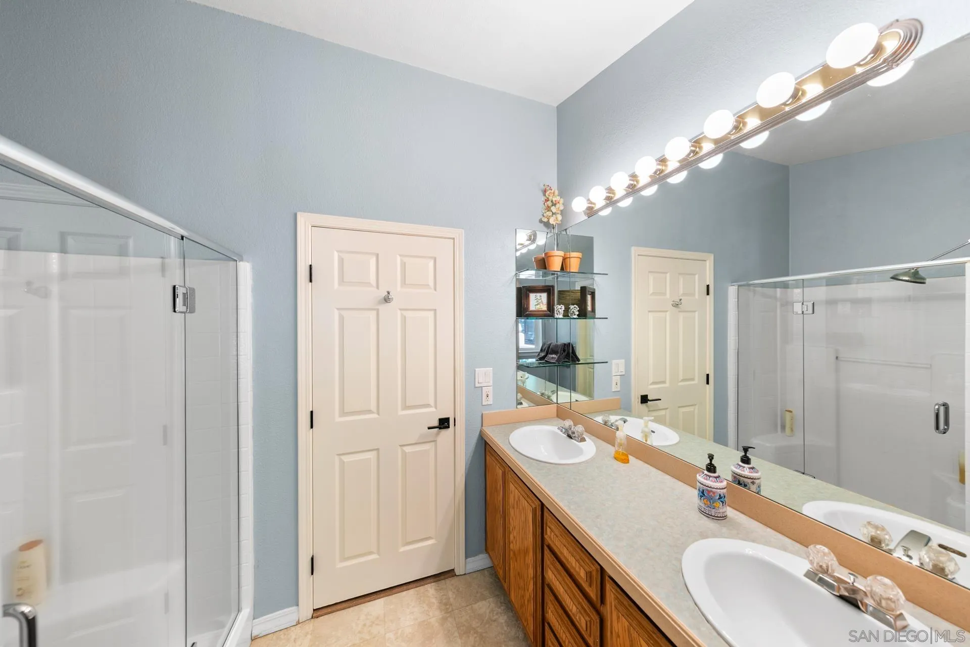 24655 Upper Rim Rock Road Idyllwild, CA 92549 - Photo 27 of 48 a bathroom with a double vanity sink mirror and shower