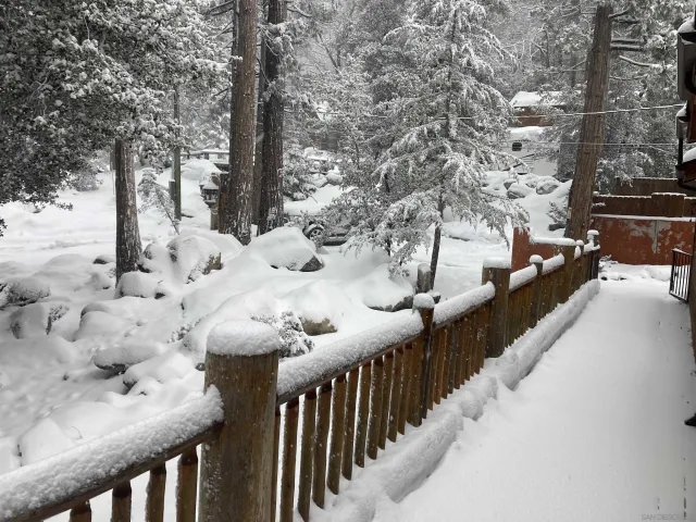 a view of a house with wooden fence