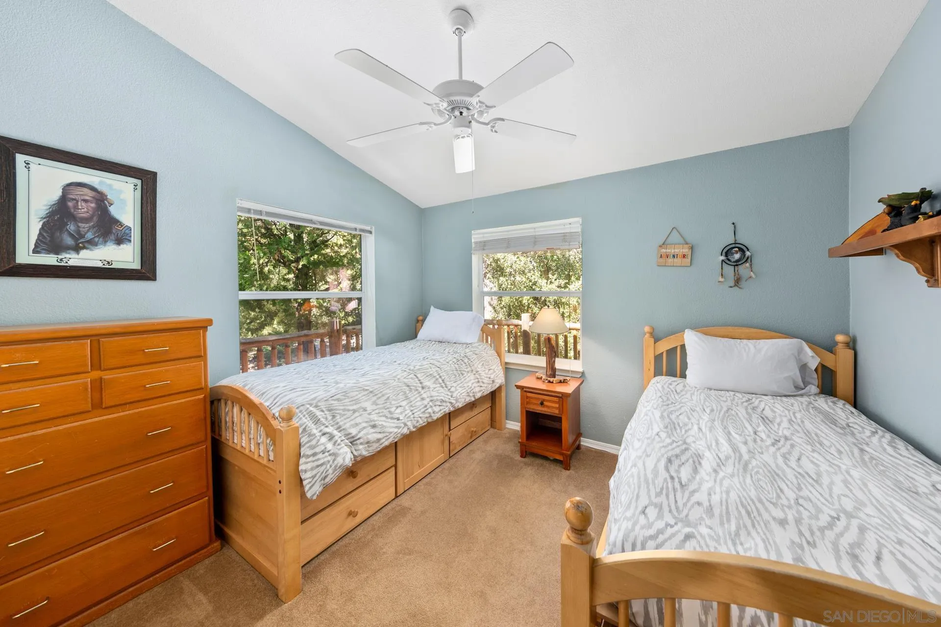 24655 Upper Rim Rock Road Idyllwild, CA 92549 - Photo 39 of 48 a bedroom with a large bed and a chandelier