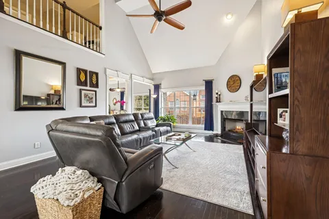 a bedroom with a bed a painting on the wall and a dresser
