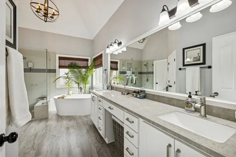 a kitchen with granite countertop a sink cabinets and stainless steel appliances