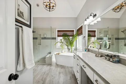 a view of a dining room with furniture large windows and wooden floor