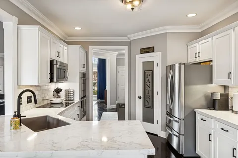 a bathroom with double vanity sink and a mirror