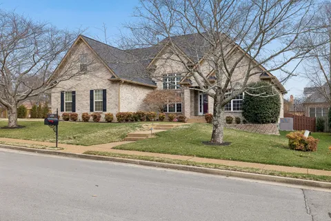 a living room with furniture and floor to ceiling windows