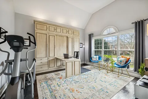 a view of a dining room with furniture and a window