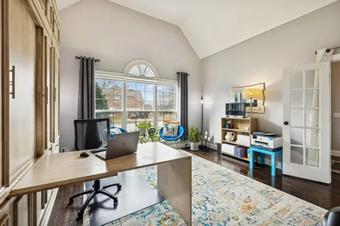 a living room with fireplace furniture and a large window