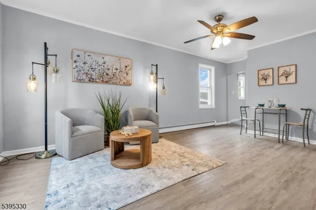 a living room with furniture and wooden floor