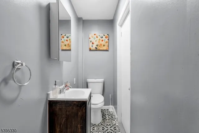 a bathroom with a toilet a sink and mirror