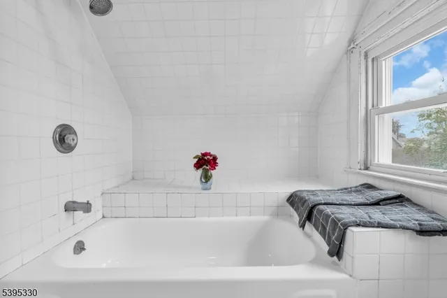 a bathroom with a tub and a window