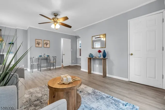 a living room with furniture and a chandelier