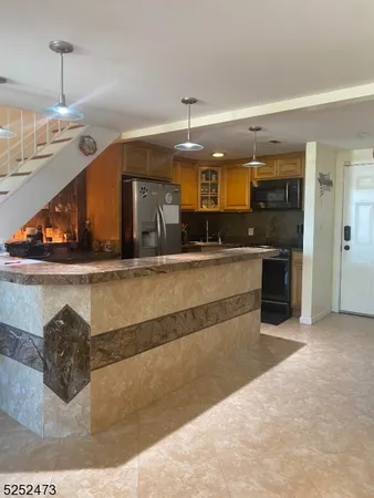a view of a kitchen with a sink and a chandelier