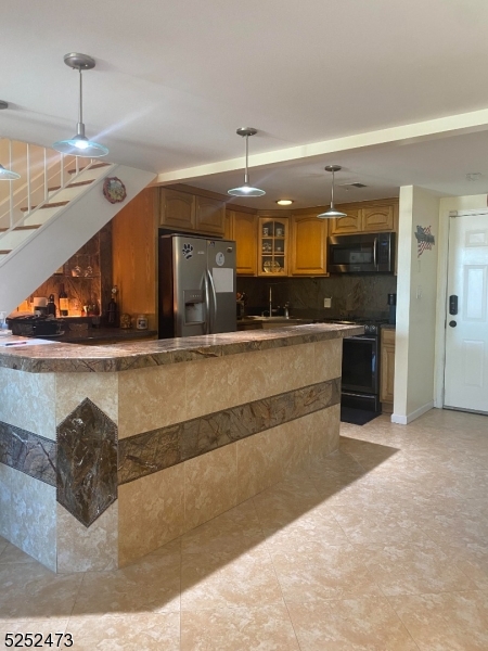 a view of a kitchen with a sink and a chandelier