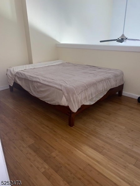 14 Jaques Street, Unit 24 Elizabeth, NJ 07201 - Photo 12 of 17 a bedroom with a bed and wooden floor