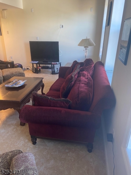 14 Jaques Street, Unit 24 Elizabeth, NJ 07201 - Photo 14 of 17 a living room with furniture and a flat screen tv