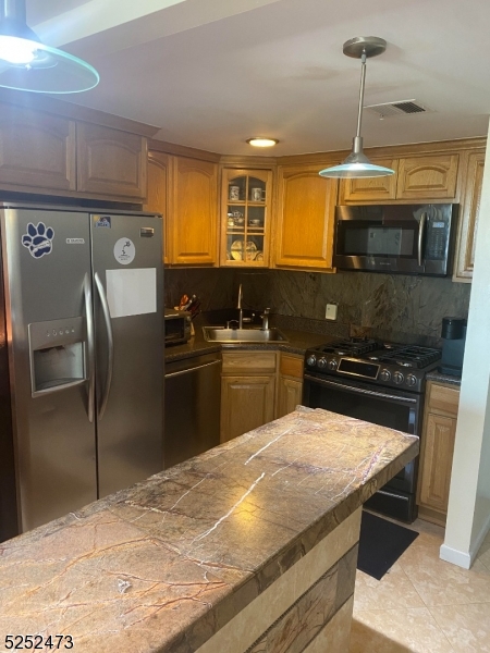 14 Jaques Street, Unit 24 Elizabeth, NJ 07201 - Photo 2 of 17 a kitchen with stainless steel appliances granite countertop a sink a stove and a refrigerator