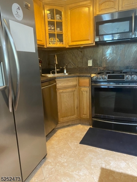14 Jaques Street, Unit 24 Elizabeth, NJ 07201 - Photo 3 of 17 a kitchen with stainless steel appliances granite countertop a stove a sink and a microwave