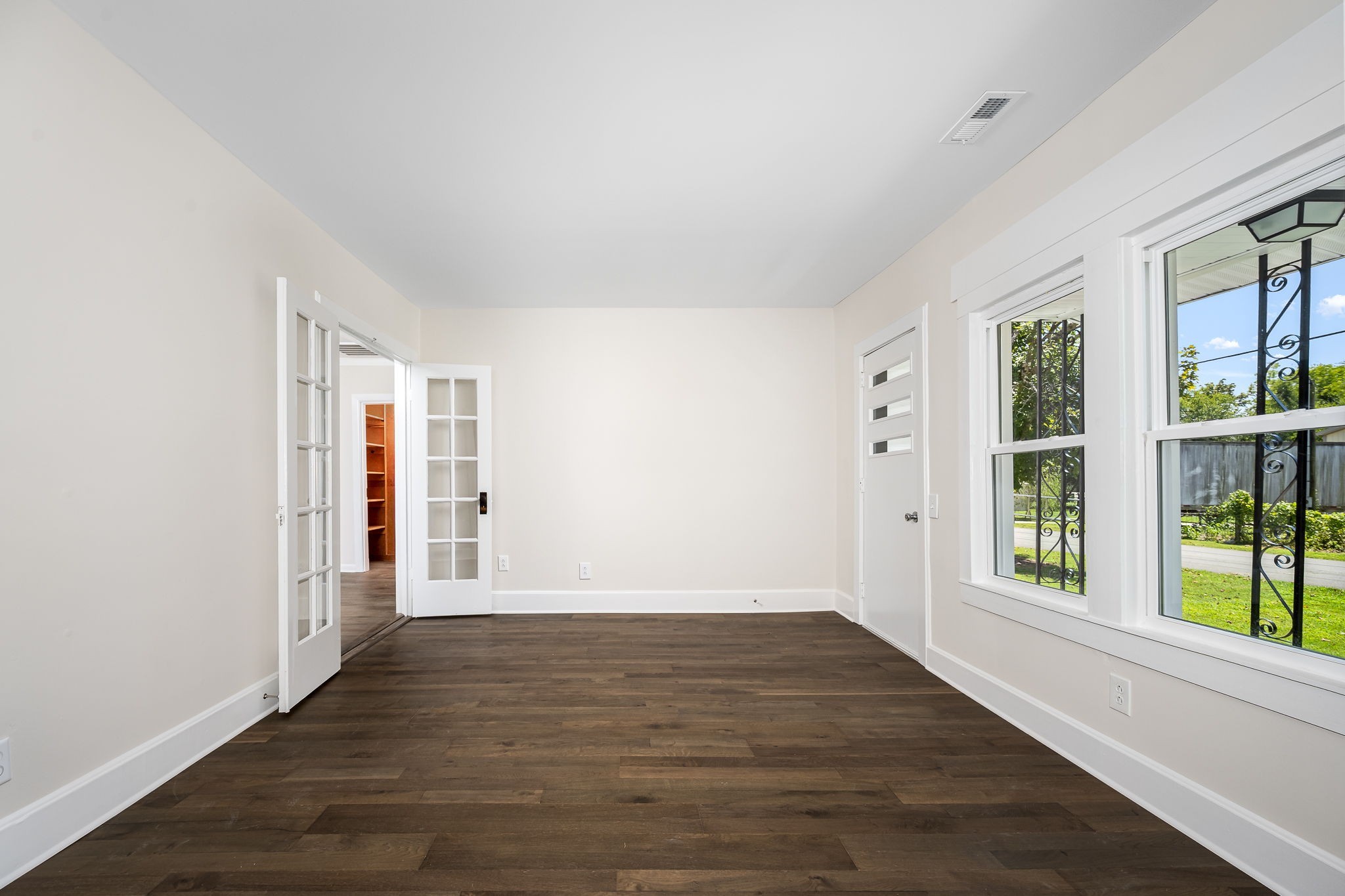 112 R E Davenport Avenue Auburntown, TN 37016 - Photo 11 of 43 a view of an empty room with wooden floor and a window