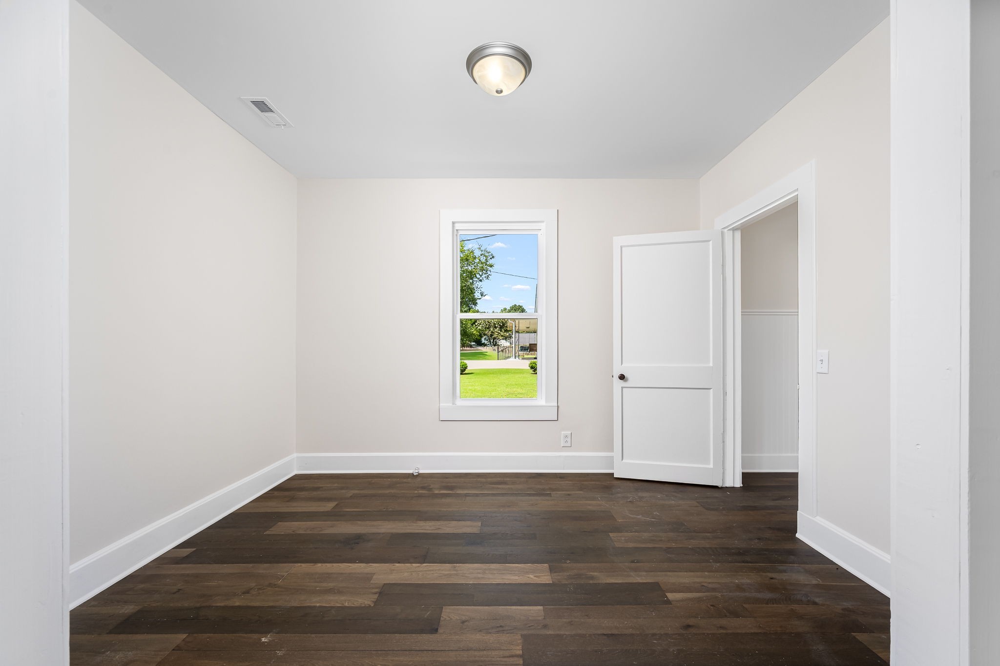 112 R E Davenport Avenue Auburntown, TN 37016 - Photo 13 of 43 a view of an empty room with wooden floor and a window