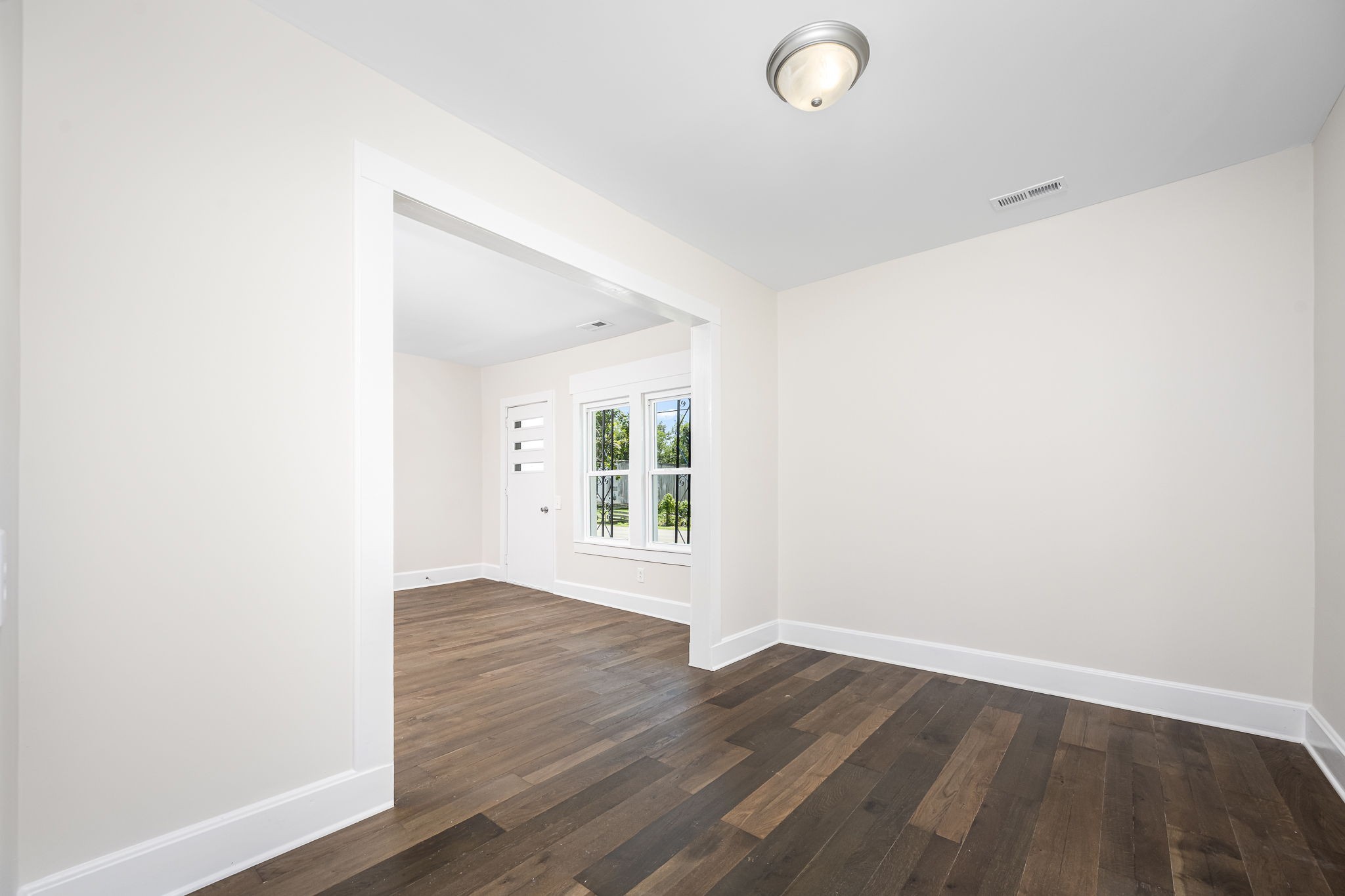112 R E Davenport Avenue Auburntown, TN 37016 - Photo 14 of 43 an empty room with wooden floor and windows