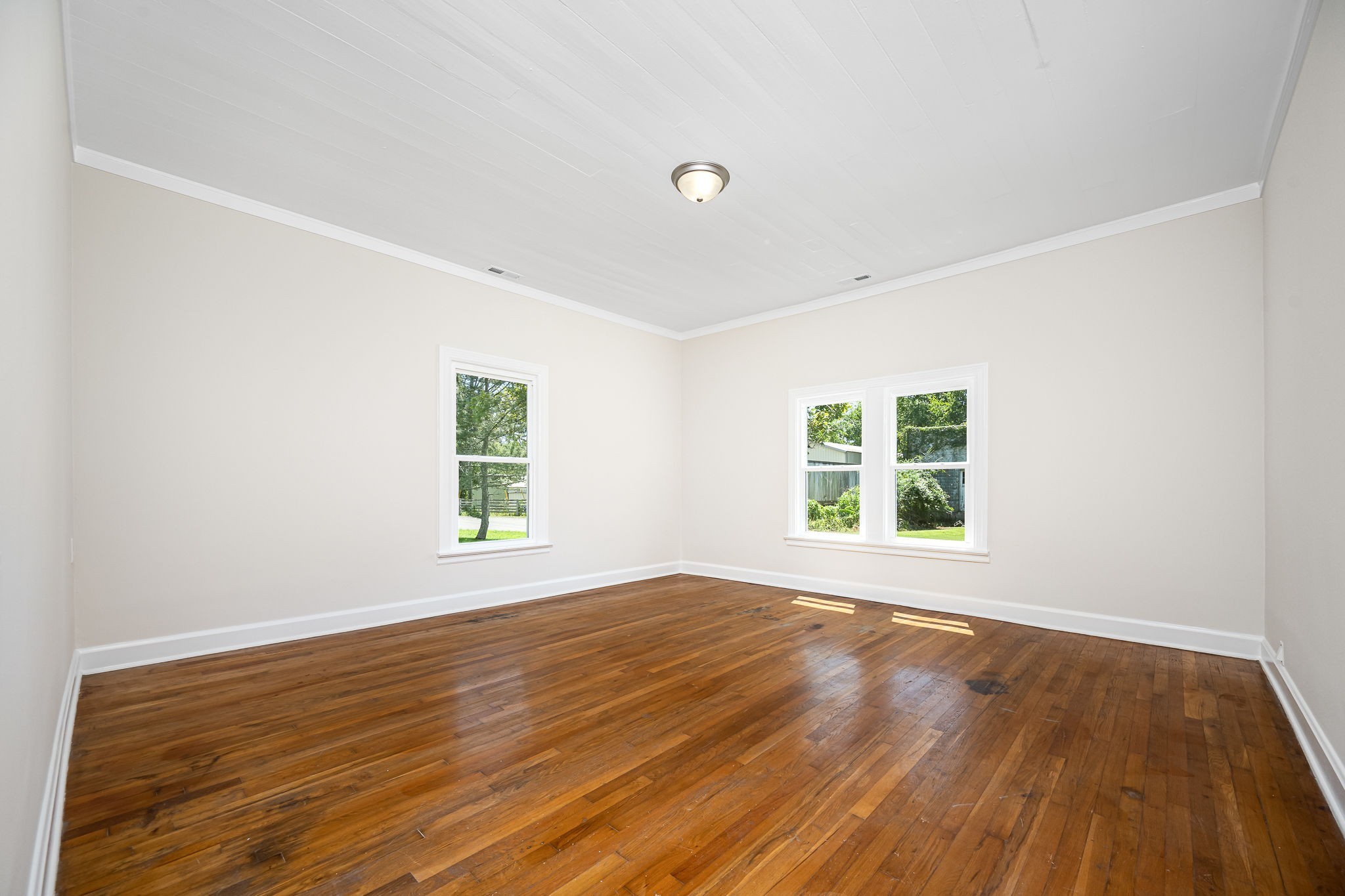 112 R E Davenport Avenue Auburntown, TN 37016 - Photo 23 of 43 an empty room with wooden floor and windows